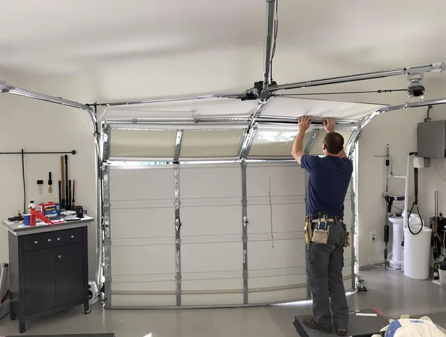 Windsor Garage Door Repair specialist performing precise section replacement on Windsor garage door